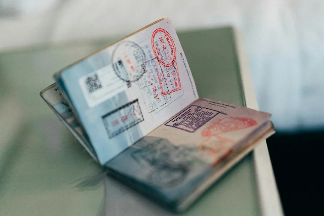 Suitcase, travel documents and a handwritten card for someone moving abroad