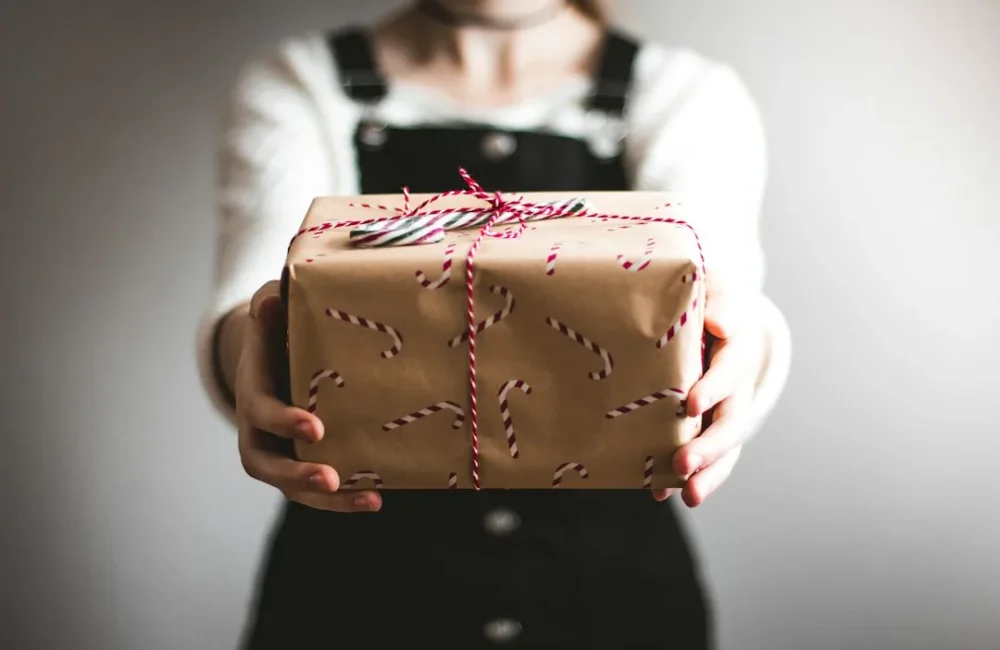Wallet, coffee and a book arranged as simple boyfriend gift ideas