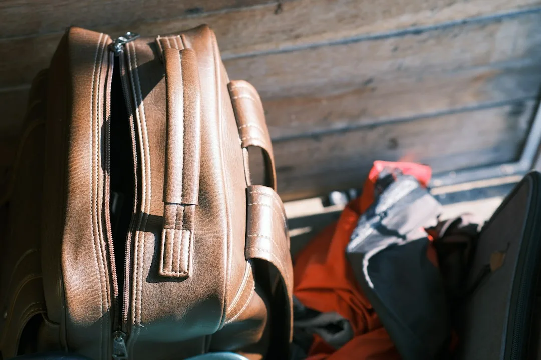 Compact travel accessories arranged beside an open carry-on bag