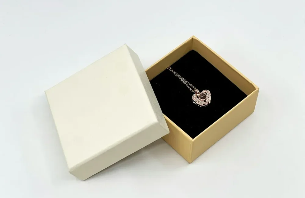 Pearl jewelry arranged beside an open gift box