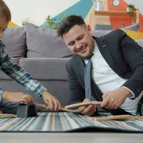 Two brothers laughing while opening a gift, illustrating gifts for a brother who has everything