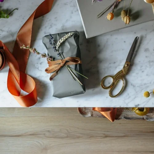 An elegantly wrapped gift with flowers, illustrating thoughtful gifts for a godmother
