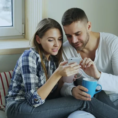 A young couple exchanging a small thoughtful gift, illustrating the best gifts for a new boyfriend