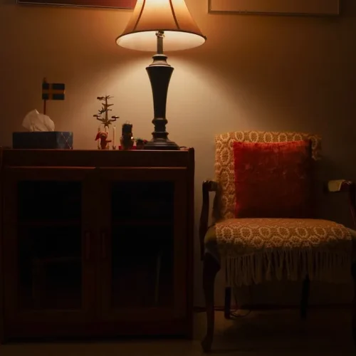 Quiet person enjoying a book alone in a comfortable corner with warm lighting