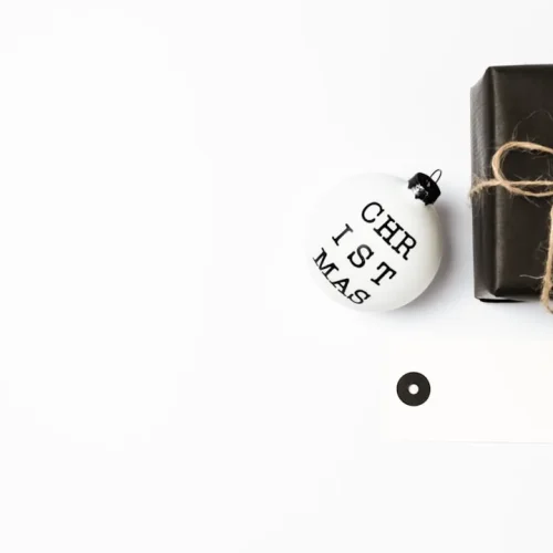 Clutter-free gift ideas including theatre tickets, premium coffee, and spa vouchers arranged on a clean minimalist surface