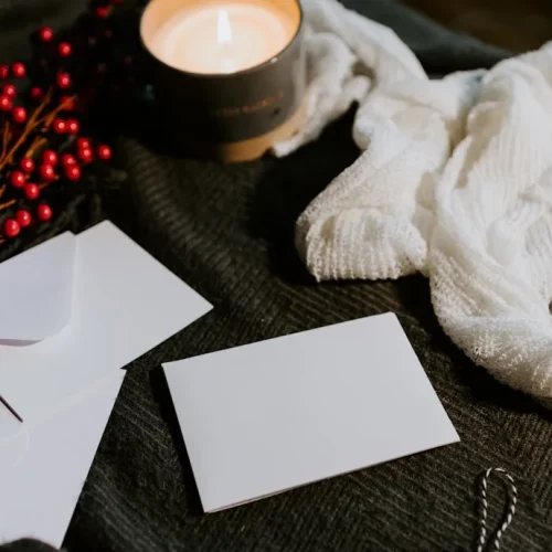 A gift envelope of cash beside a handwritten note, showing a thoughtful way to give money as a present