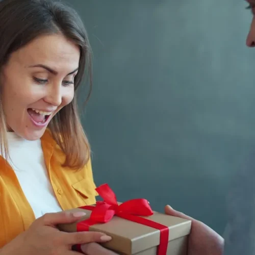 Thoughtful sentimental gifts for wife including photo album, handwritten letters, and personalised keepsakes arranged on elegant surface